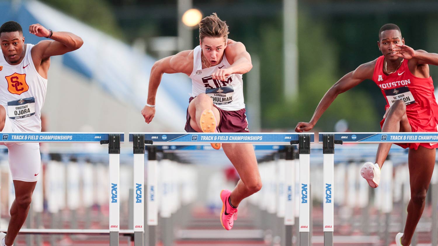 A ϲʹ̳ track athlete leaps over a hurdle during a race