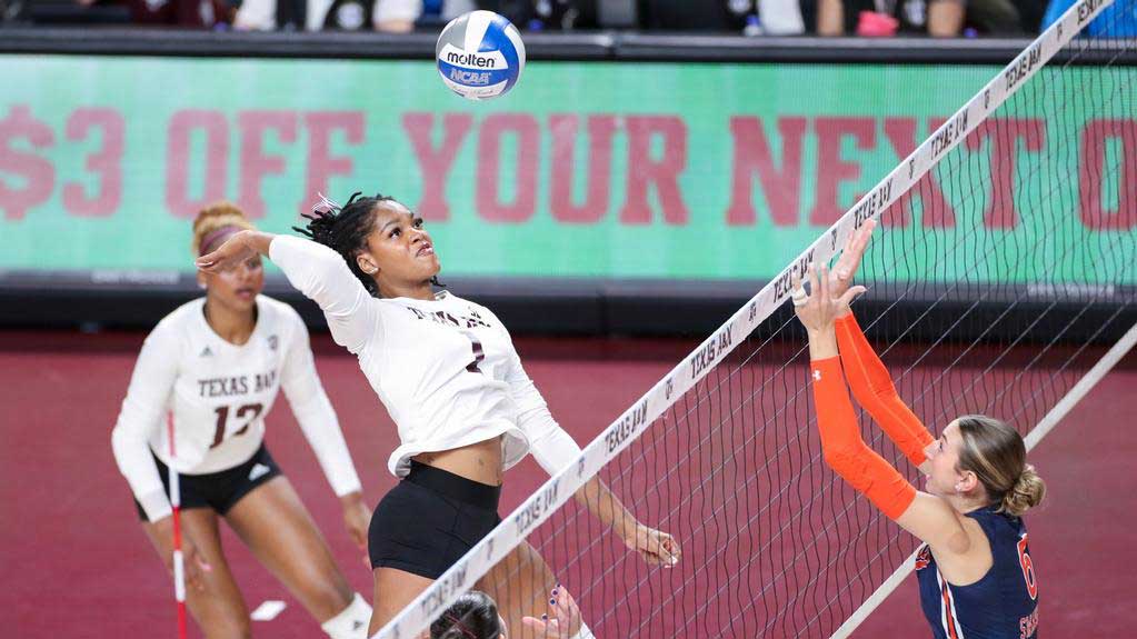 A ϲʹ̳ volleyball player spikes the ball over the net