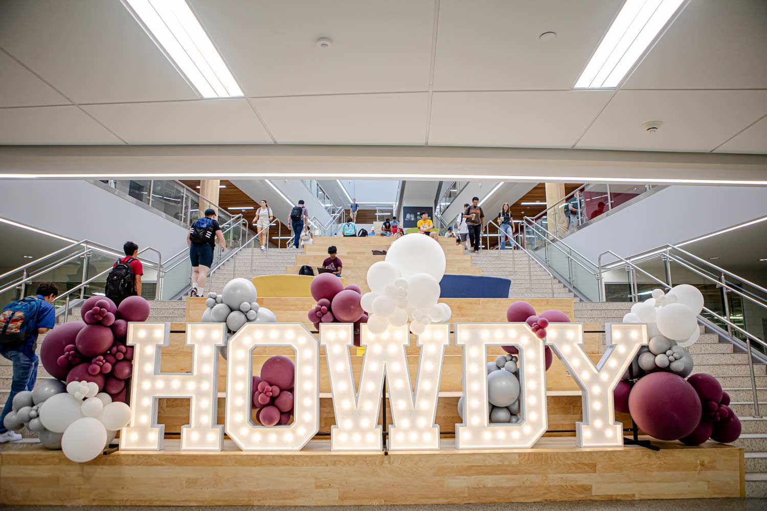 Light-up HOWDY sign on the indoor main staircase of Zachry Engineering Education Complex on the ϲʹ̳ Campus